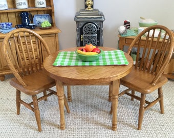 Summer Oak Round Table and two chairs with Reversible Placement and Bowl of Fruit (additional chairs available)