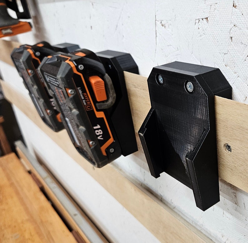 Ridgid 18V Battery holder with French cleat option.  Slight angle for easy removal.