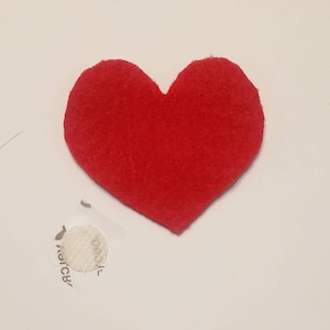 May include: A red felt heart shape.