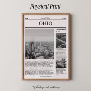 May include: A framed black and white print featuring a newspaper-style layout about Ohio. The print includes the headline "OHIO", images of the state, and text describing the state's history and geography. The frame is a light brown color.