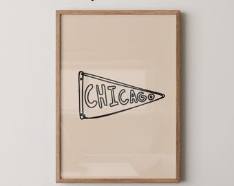 May include: A framed print featuring a beige background with a black pennant that reads "CHICAGO." The pennant is a simple, hand-drawn style. The words "Physical Print" are at the top, and "Whiskey and Honey" is at the bottom.
