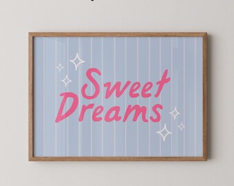 May include: A framed print with a light blue background and vertical white stripes. The words "Sweet Dreams" are in pink script, with white starburst accents. The frame is a light brown color. The text "Physical Print" is at the top.