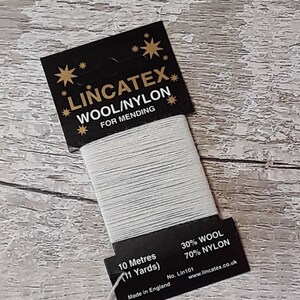 May include: A spool of light grey Lincatex wool/nylon thread for mending. The black label reads "WOOL/NYLON FOR MENDING" and includes the text "10 Metres (11 Yards)". The thread is 30% wool and 70% nylon.