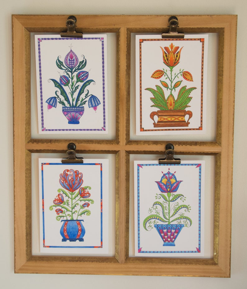 May include: Four framed art prints featuring colorful stylized floral designs. Each print depicts a different flower in a pot with a unique pattern. The flowers are in shades of pink, orange, red, and blue.