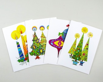May include: Set of four Christmas cards featuring colorful, whimsical illustrations of Christmas trees and candles. The cards are blank inside for writing messages.