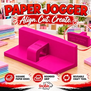 May include: A bright pink paper jogger tool featuring an L-shaped design with a central handle. The handle is embossed with the letters RVB. A smaller inset image shows the same tool with the text Rockin' Vinyl Blanks, ALIGN. CUT. CREATE.