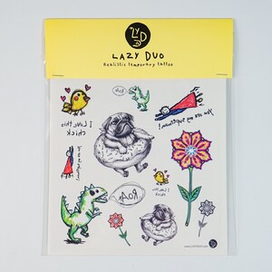 May include: A sheet of "LAZY DUO" realistic temporary tattoos. Designs include a pug in a donut, a dinosaur, a superhero, a flower, and a bird. The sheet is packaged in a clear plastic sleeve with a yellow header.