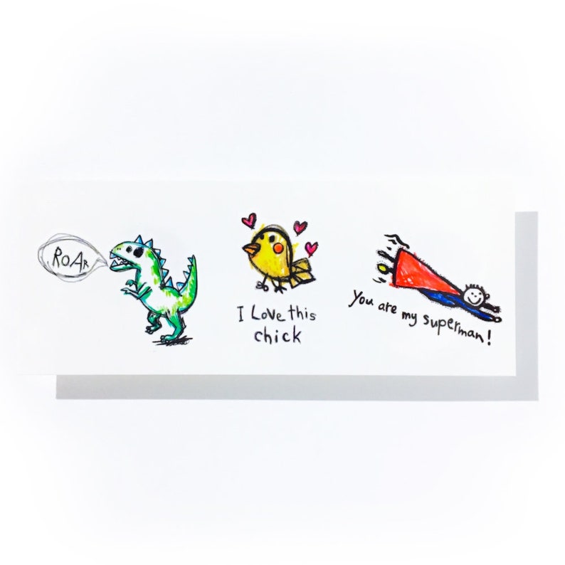 May include: A white greeting card featuring three hand-drawn illustrations. A green dinosaur with "ROAR", a yellow bird with "I Love this chick", and a stick figure with a red cape and the text "You are my superman!"