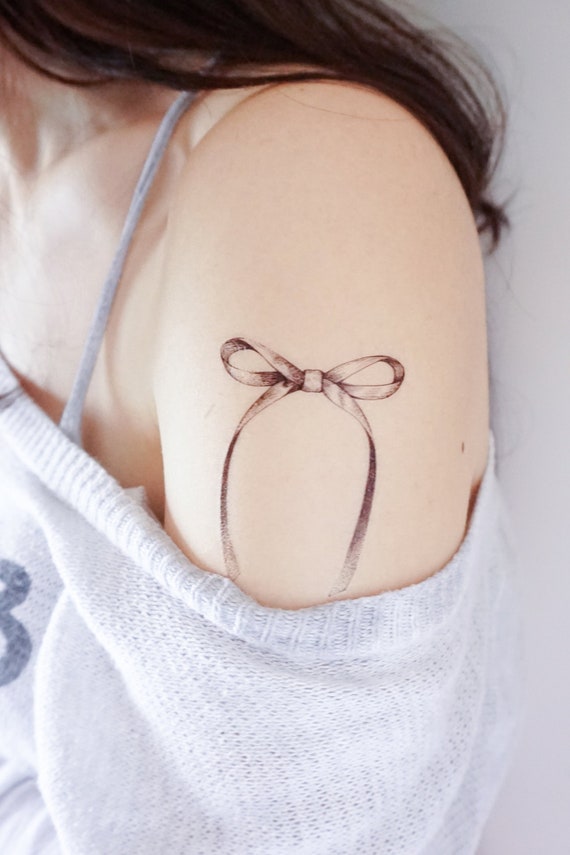 Beautiful meaning behind bow tattoo 🎀✨ (typo *femininity) | Instagram