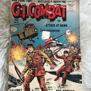 Op de afbeelding: Vintage G.I. Combat stripboek, juni nr. 37, met een oorlogsthema op de cover. De illustratie toont soldaten, tanks en een helikopter in een gevechtsscene. Het stripboek heeft een versleten uiterlijk, met de titel en het nummer duidelijk zichtbaar.