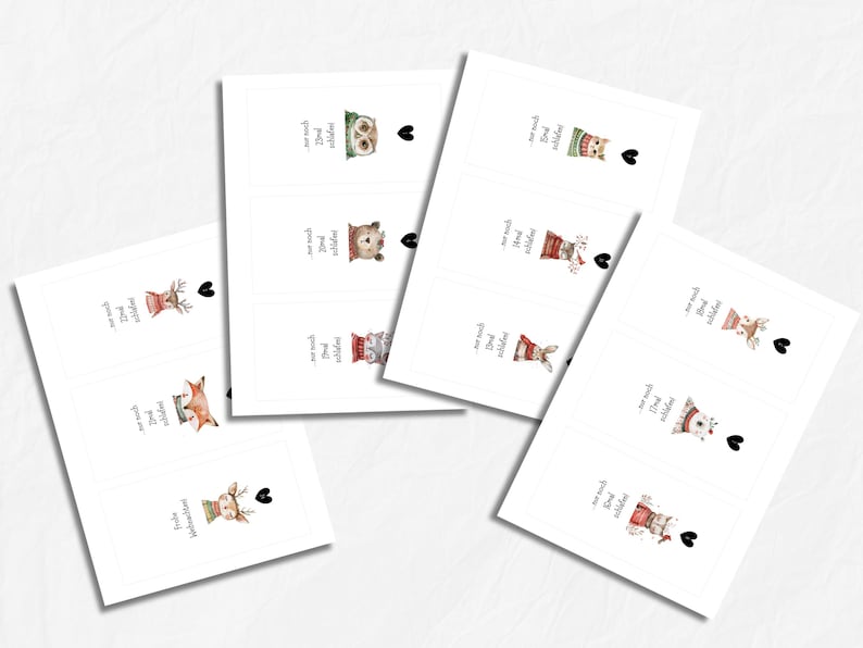 May include: White rectangular cards with watercolor illustrations of animals in winter attire. Each card features an animal, a heart, and German text. Animals include an owl, bear, cat, rabbit, and deer.