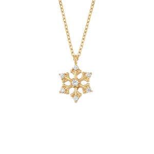 May include: A gold snowflake pendant necklace with clear sparkling stones.