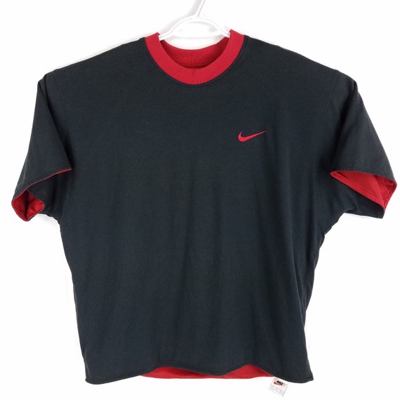 black nike shirt with red swoosh