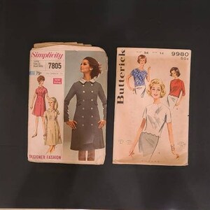 May include: Two vintage sewing patterns, one from Simplicity and one from Butterick. The Simplicity pattern is for a dress and coat, and the Butterick pattern is for a dress. Both patterns feature women in the illustrations.