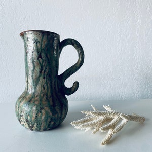 Old enamelled terracotta pitcher