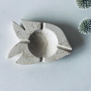 Travertine fish pocket emptier