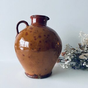 Ancient pitcher in glazed terracotta