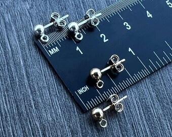 May include: Close-up of four earring backs with a ruler for scale. Two earring backs are silver with a 4mm ball and two are gold with a 4mm ball.