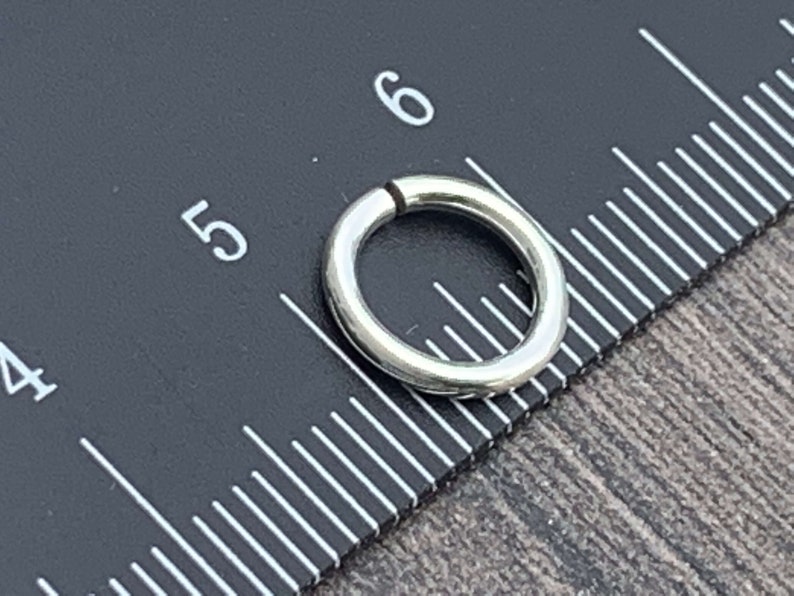 May include: A silver jump ring measuring 5/16 inches in diameter.
