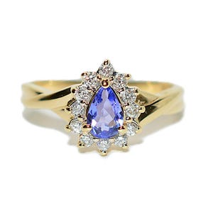 14 kt gouden ring met tanzaniet en diamant: halo peer, geboortesteen december