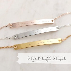 May include: Three stainless steel bar necklaces with delicate chains. Each bar has a different engraved pattern.