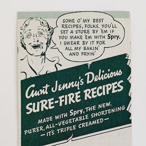 May include: A vintage advertisement for Spry shortening featuring a woman and a man. The text reads "Some o' my best recipes, folks, you'll set a store by 'em if you make 'em with Spry. I swear by it for all my bakin' and fryin'. Aunt Jenny's Delicious Sure-Fire Recipes Made with Spry, the new, purer, all-vegetable shortening - it's triple creamed - Jenny always was a dandy cook. But she's a humdinger since she changed to that Spry. Her pies and fried foods don't give me indigestion either!"