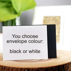 May include: A white card with black text that reads "You choose envelope colour: black or white".