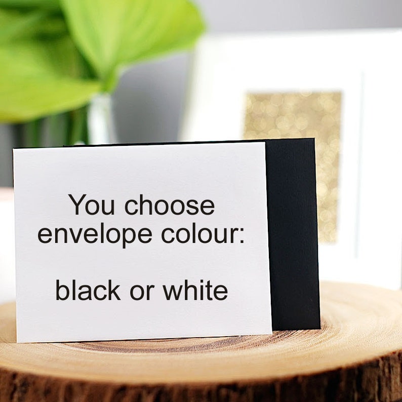 May include: A white card with black text that reads "You choose envelope colour: black or white".