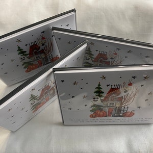 May include: A set of four Halloween greeting cards featuring a spooky house with ghosts, pumpkins, and stars. The text on the card reads "Treats are always better outside, when all the spooky fun is close and the creatures are easily accessible at the door."
