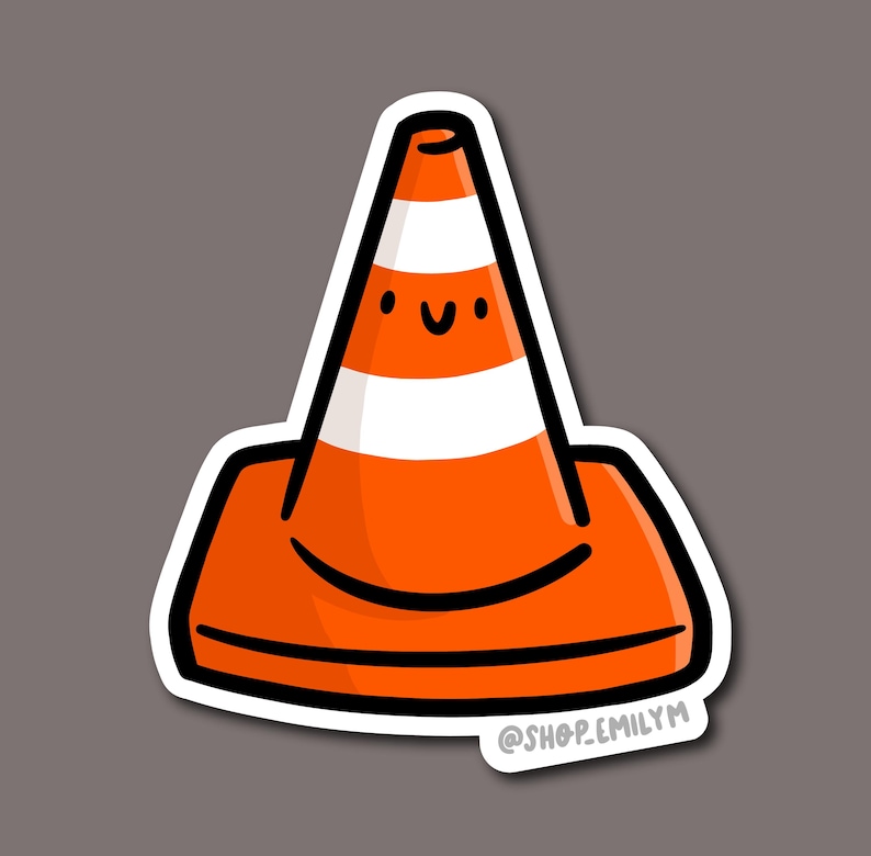May include: A sticker featuring a cartoon traffic cone with a smiling face. The cone is orange with a white stripe and a black outline. The sticker has a white border and the text "@shop.emilym".