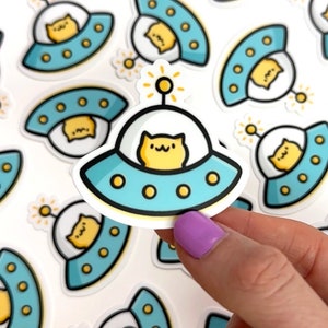 Pegatina de vinilo de mini gato espacial, pegatina impermeable para teléfono, pegatina de gato kawaii, pegatina linda del espacio exterior, pegatina de OVNI, pegatina de platillo volador