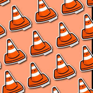 May include: A repeating pattern of orange and white traffic cone stickers with smiling faces on a peach background. The stickers have a black outline and the text "@SHOP.EMILYM".