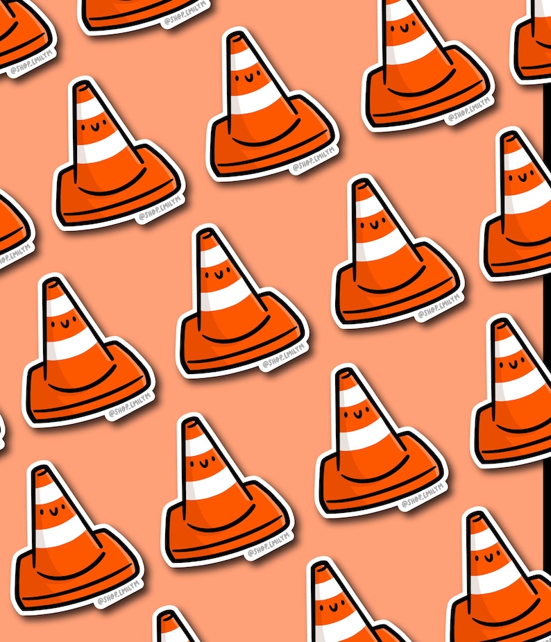 May include: A repeating pattern of orange and white traffic cone stickers with smiling faces on a peach background. The stickers have a black outline and the text "@SHOP.EMILYM".