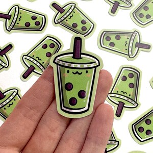May include: A set of 10 green and black bubble tea stickers with cute faces. The stickers are perfect for adding a touch of fun to your laptop, water bottle, or planner.