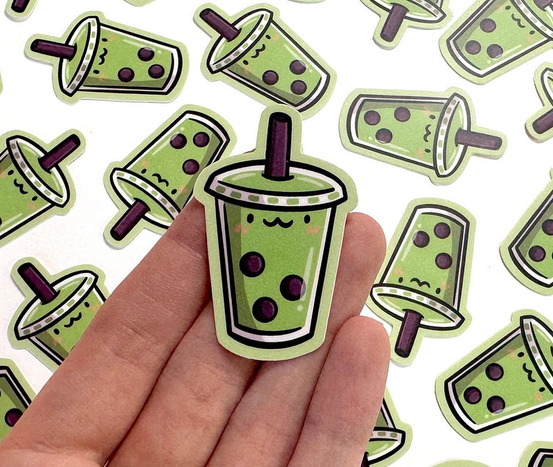 May include: A set of 10 green and black bubble tea stickers with cute faces. The stickers are perfect for adding a touch of fun to your laptop, water bottle, or planner.