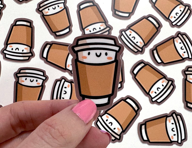 May include: A sheet of stickers featuring cartoon coffee cups with smiling faces. The stickers are brown and white with black outlines.