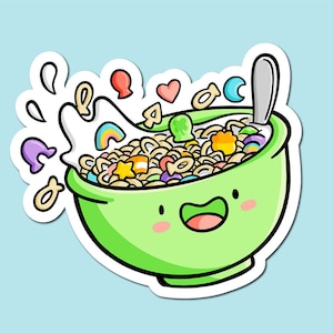 Puede incluir: Un tazón verde con una cara sonriente lleno de cereales, leche y chispas de colores. El tazón tiene un borde blanco y una pegatina blanca alrededor. Hay corazones, estrellas y otras formas flotando alrededor del tazón.