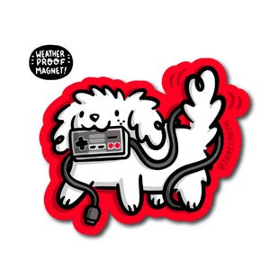 May include: A white cartoon dog sticker with a red border, holding a grey video game controller. The controller is connected to the dog with a black cable. The sticker has the text "WEATHER PROOF MAGNET!" in a black circle.