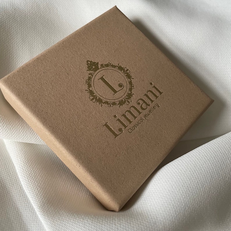 May include: A brown cardboard box with a gold logo that says "Limani Classical Jewellery".