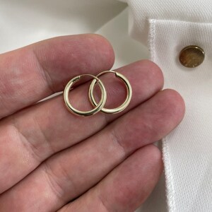 Op de afbeelding: Een paar gouden creolen. De oorbellen zijn simpel en klassiek en zouden een geweldige aanvulling zijn op elke sieradencollectie.