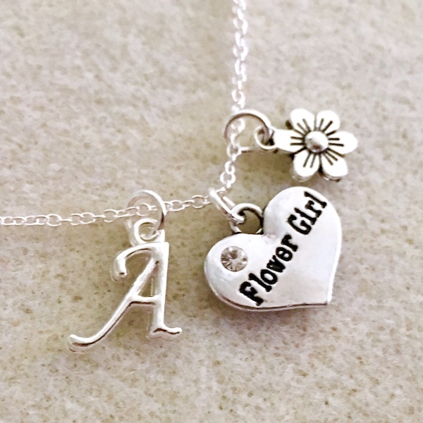 May include: Silver necklace with a heart charm that says "Flower Girl" and a letter A charm. The necklace also has a small flower charm.
