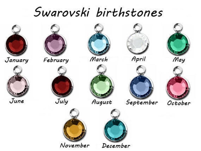 May include: A chart showing Swarovski birthstones for each month of the year. The stones are displayed in silver settings. January: red, February: purple, March: blue, April: white, May: green, June: pink, July: red, August: green, September: blue, October: pink, November: gold, December: teal.