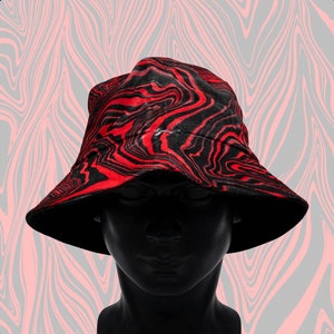 May include: A black and red bucket hat with a swirling, marbled pattern.