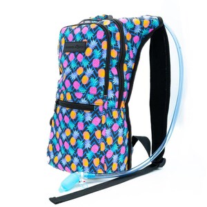 May include: A black hydration backpack with a blue, pink, and yellow pineapple print. The backpack has a clear tube for drinking water.