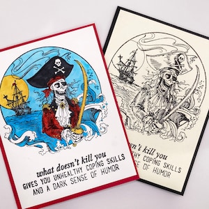 May include: A humorous greeting card featuring a cartoon skeleton pirate with a sword, a ship, and the text "what doesn't kill you gives you unhealthy coping skills and a dark sense of humor".
