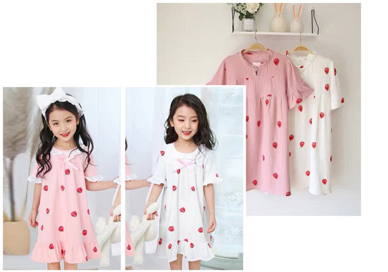 May include: Two girls wearing pink and white strawberry print nightgowns with lace trim. The nightgowns have short sleeves and a ruffled hem.