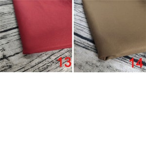 May include: Two fabric swatches, one red and one brown, are laid out on a wooden surface. The swatches are labeled with the numbers 13 and 14.