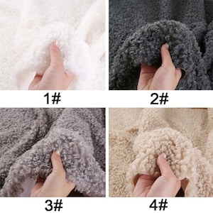 May include: Four samples of faux fur fabric in different colors: white, gray, light gray, and beige. Each sample is held in a hand to show the texture.