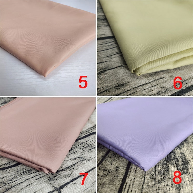 May include: Four fabric swatches in different colors: light pink, light green, light pink, and light purple. The swatches are folded and placed on a wooden surface.