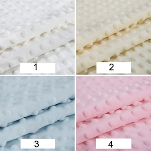 May include: Four fabric swatches with a textured, dotted pattern. The swatches are in four colours: white, cream, light blue, and pink. The swatches are numbered 1 through 4.